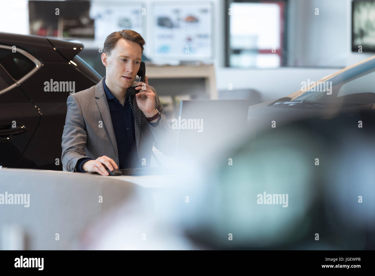 Car salesperson talking on landline phone Stock Photo Alamy