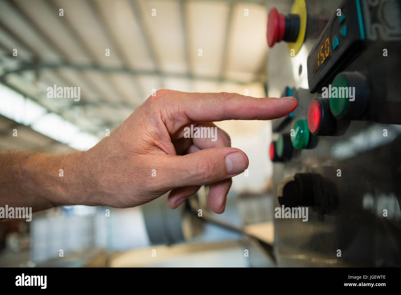 Hand pressing a control button in factory Stock Photo - Alamy