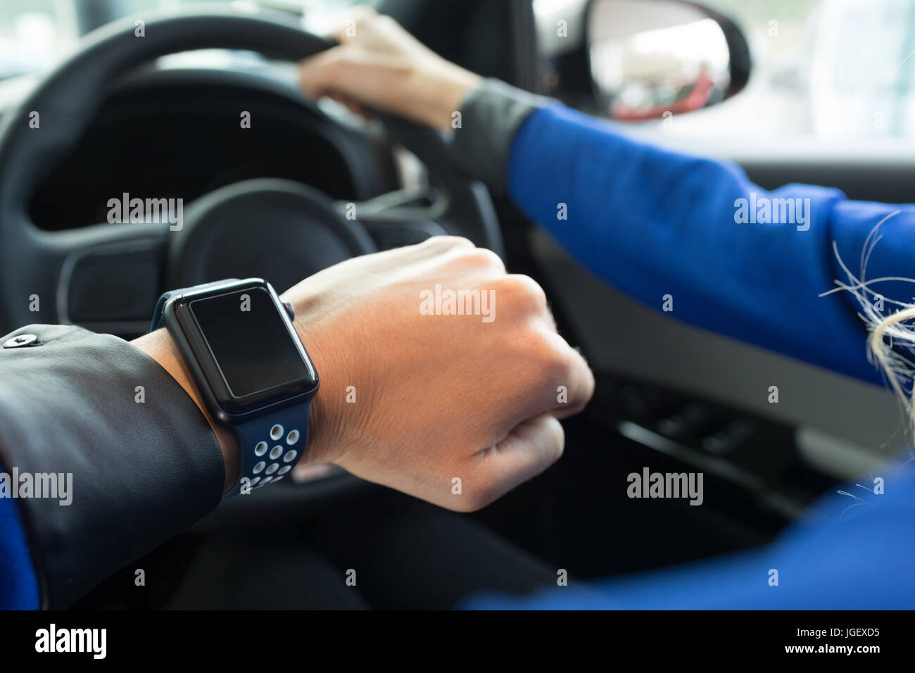 Cropped image of woman wearing wristwatch in car Stock Photo