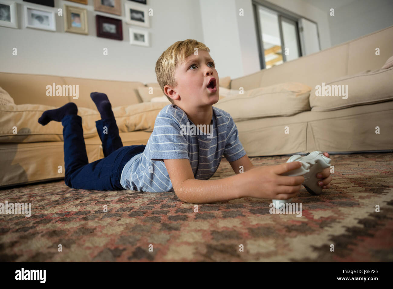 Boy playing video game in the living room at home Stock Photo Alamy