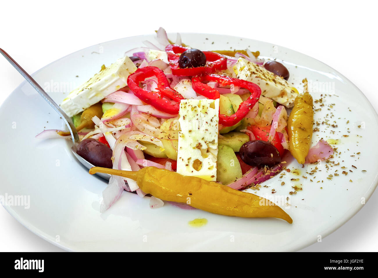 Fresh vegetable Greek salad with tomatoes, cucumbers, peppers, onion, olives and white cheese. Stock Photo