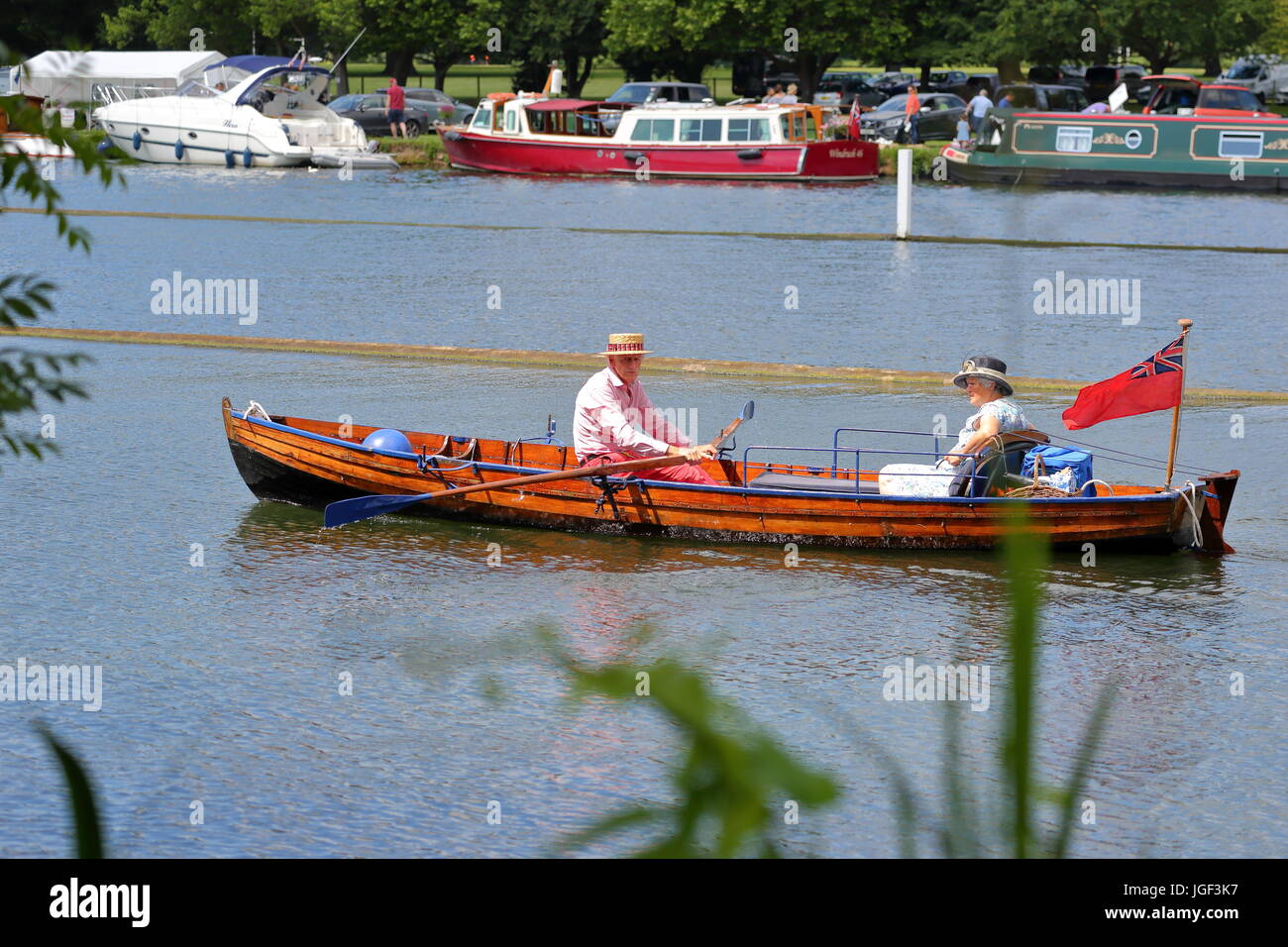 Rowers and visitors alike enjoyed the final day of Henley Royal Regatta 2017, An elderly couple rowing in a classic wooden boat. Stock Photo