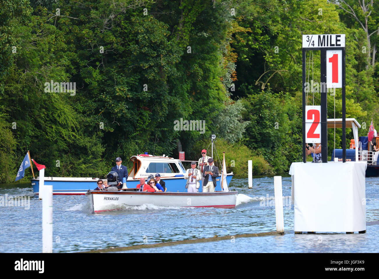 The umpire boat racing behind the competitors at the  Henley Royal Regatta 2017 Stock Photo