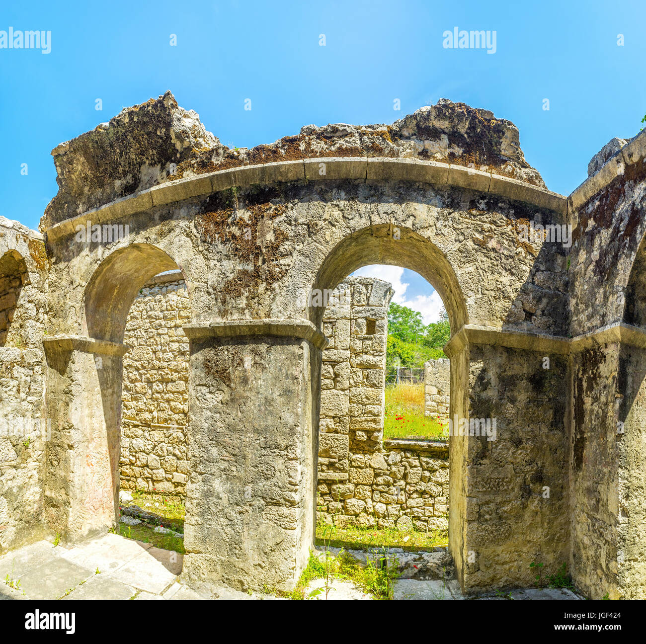 The ruined wall with two arches separates visitors area and archaeological zone of St Nicholas Church complex, Demre, Turkey. Stock Photo