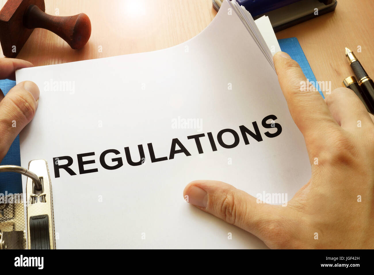 Documents with title Regulations on a table. Stock Photo