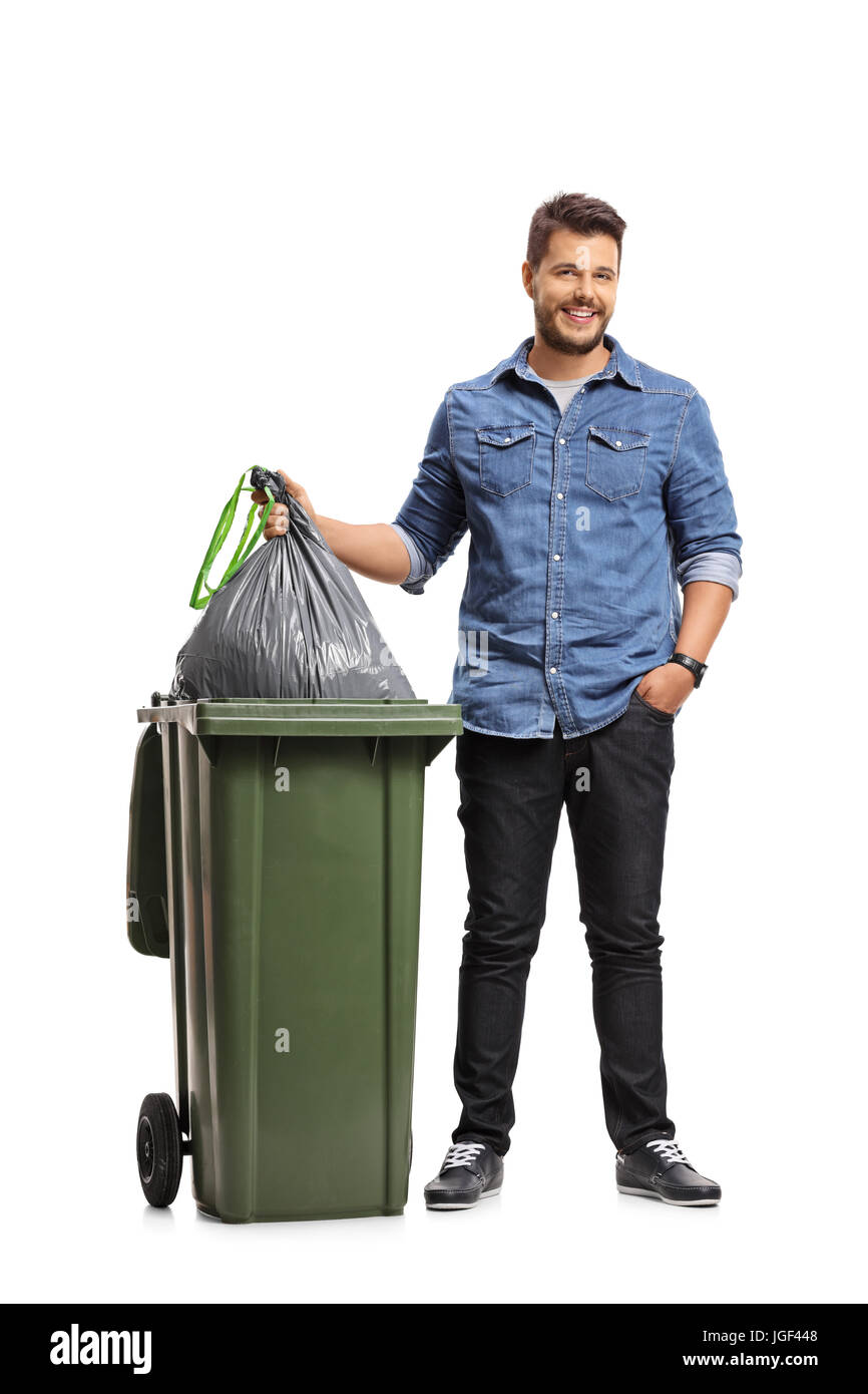 Full length portrait of a guy taking out the garbage isolated on white background Stock Photo