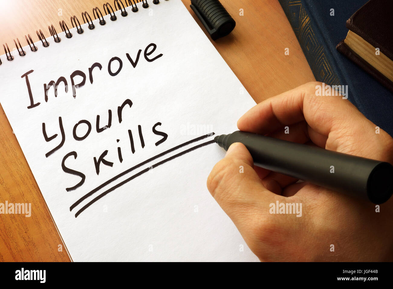 Notepad with handwriting title Improve Your Skills. Stock Photo