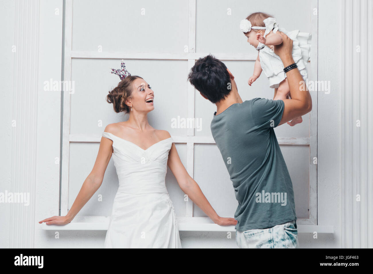 Happy family on a white background in white clothes Stock Photo - Alamy