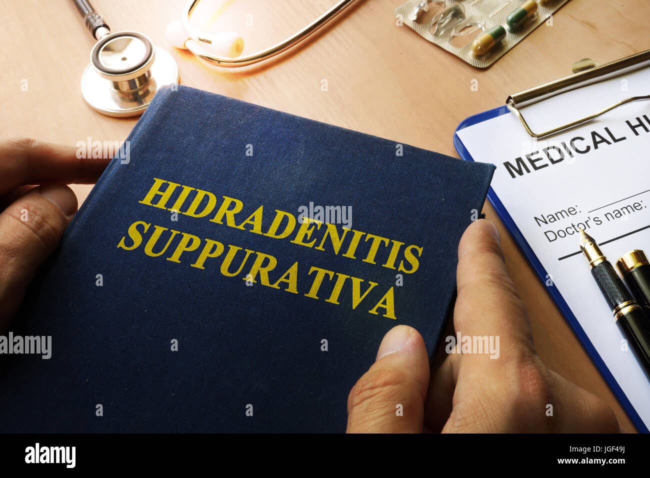 Book with title Hidradenitis Suppurativa on a table. Stock Photo