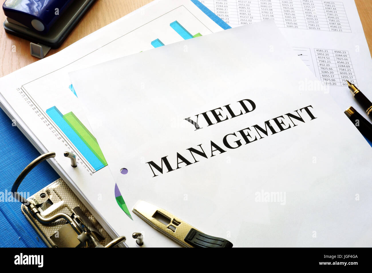 Folder and documents with title Yield management. Stock Photo