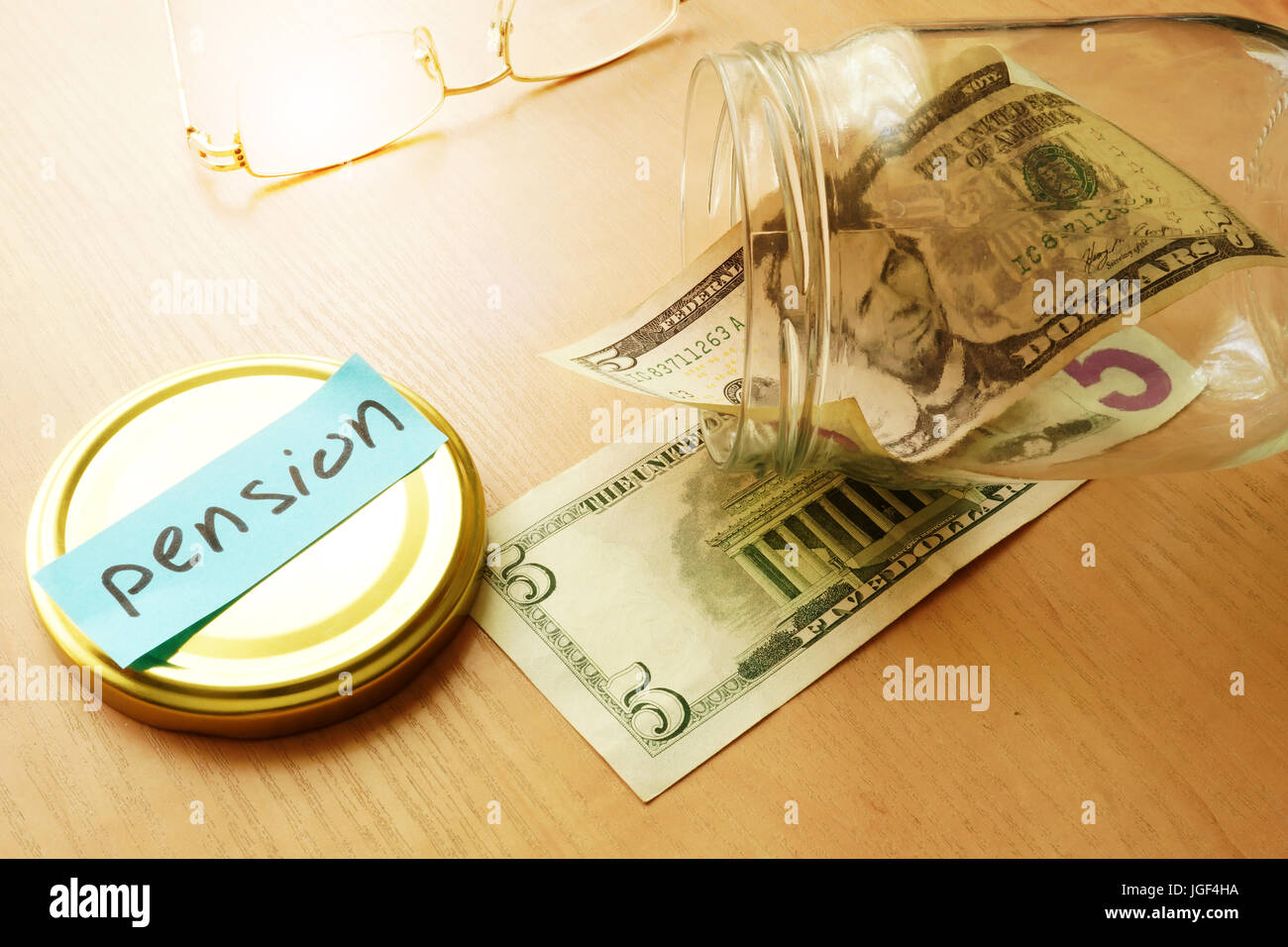 Almost empty jar with label pension. Retirement savings problems. Stock Photo
