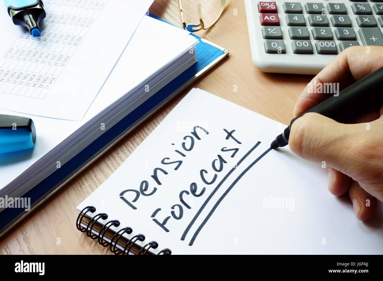 Handwriting sign pension forecast in a note. Stock Photo