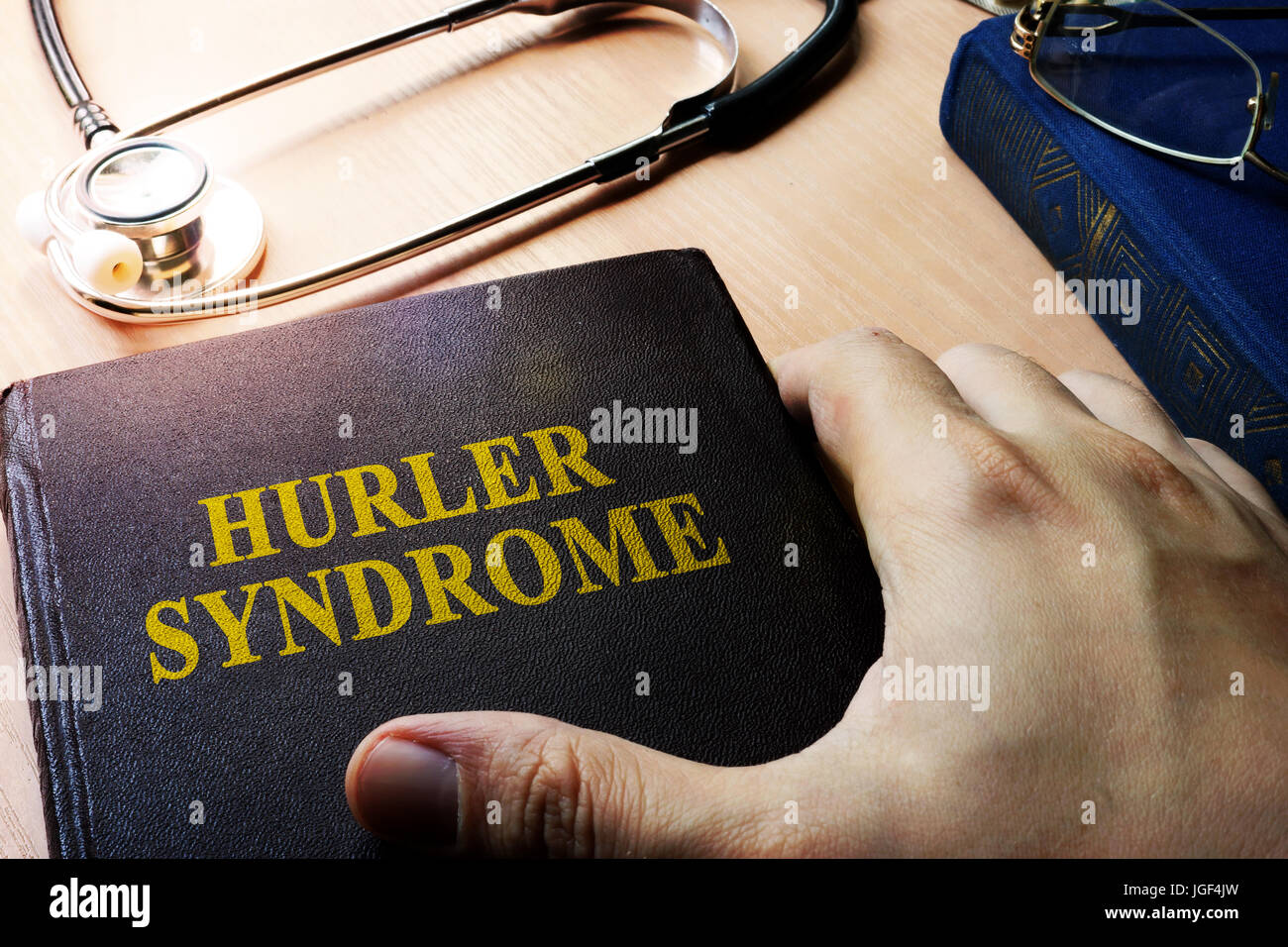 Hands holding book Hurler syndrome. Stock Photo