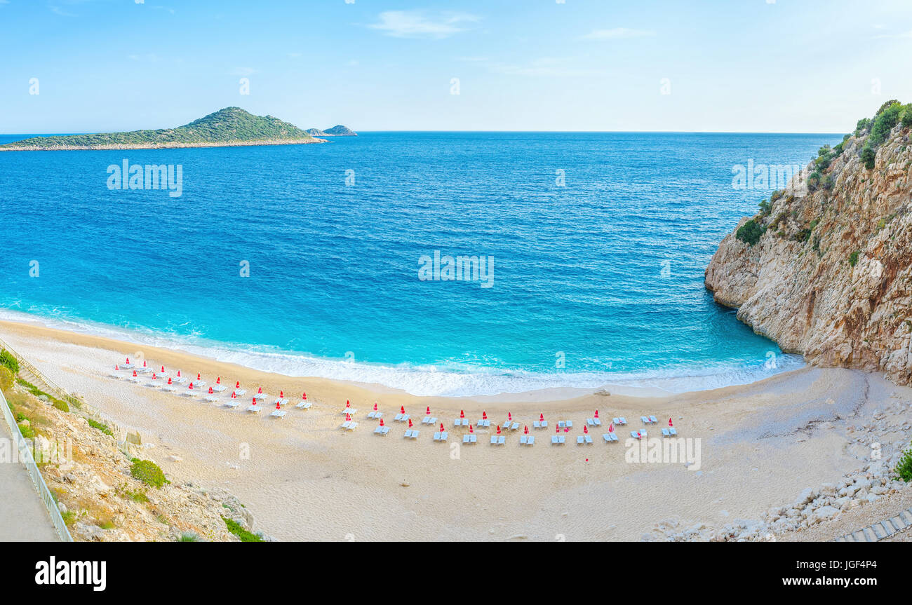 The scenic Kaputas beach with rows of sun beds boasts clean sand and pleasure warm water, Kalkan, Turkey Stock Photo