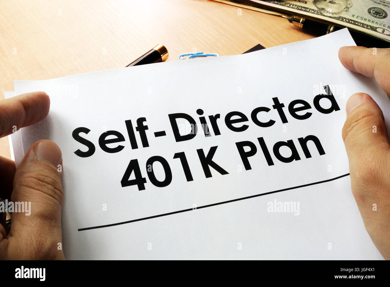 Self directed 401k plan written on a paper. Stock Photo