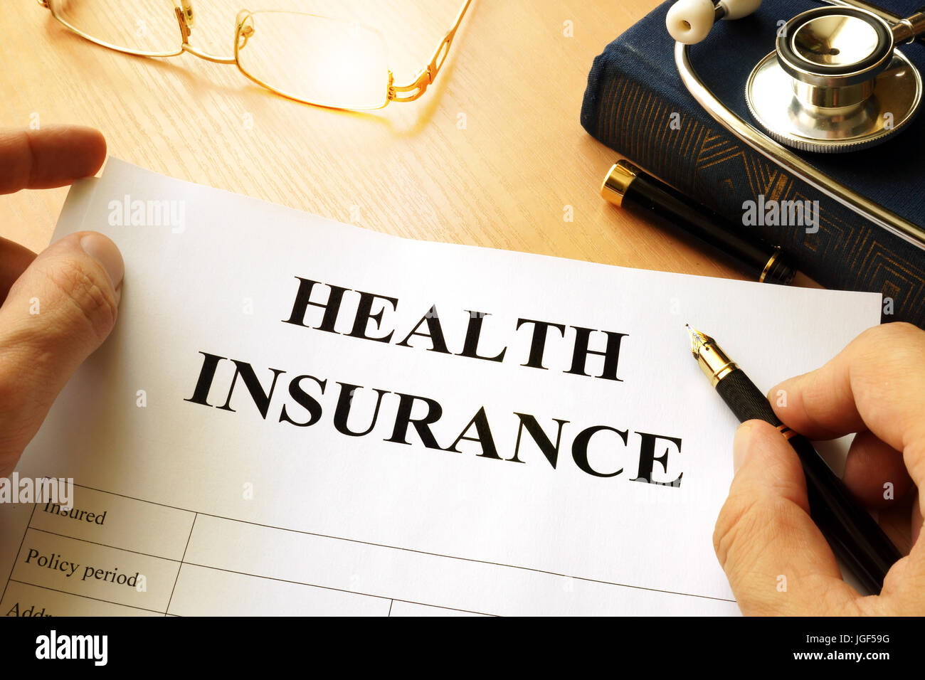 Health insurance policy on a table. Stock Photo