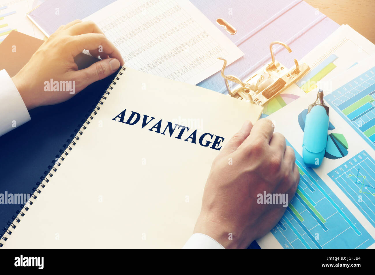 Manager taking book with name Advantage. Stock Photo