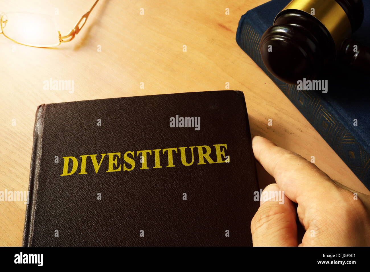 Book with title divestiture and gavel. Stock Photo