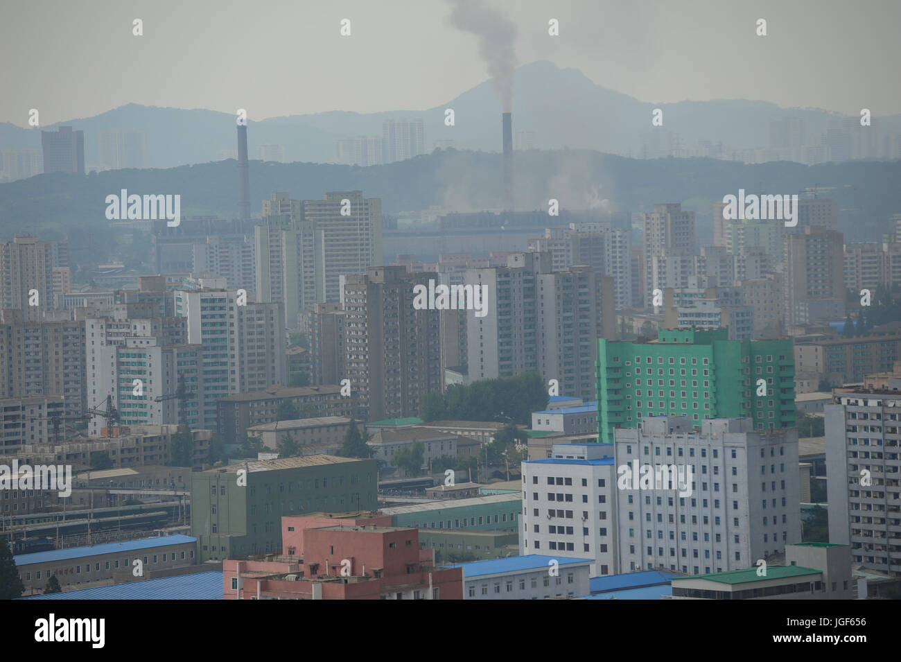 09.08.2012, Pyongyang, North Korea, Asia - An elevated view of central Pyongyang with multi-storey residential buildings and a power station. Stock Photo