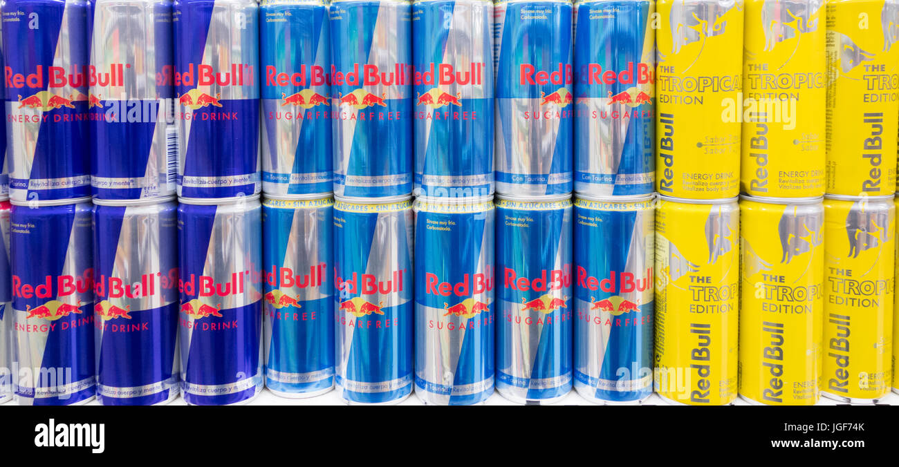 Red bull energy drinks display: normal, sugar free and tropical edition Stock Photo