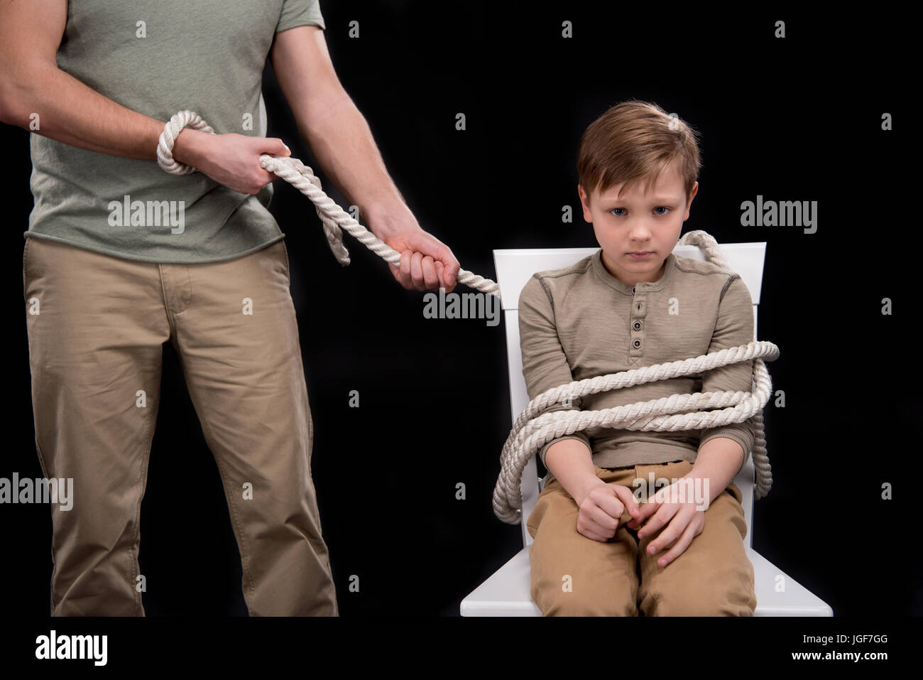 A Man Sits On A Chair Supported By A Rope Man Tied To Chair High Resolution Stock Photography and Images - Alamy