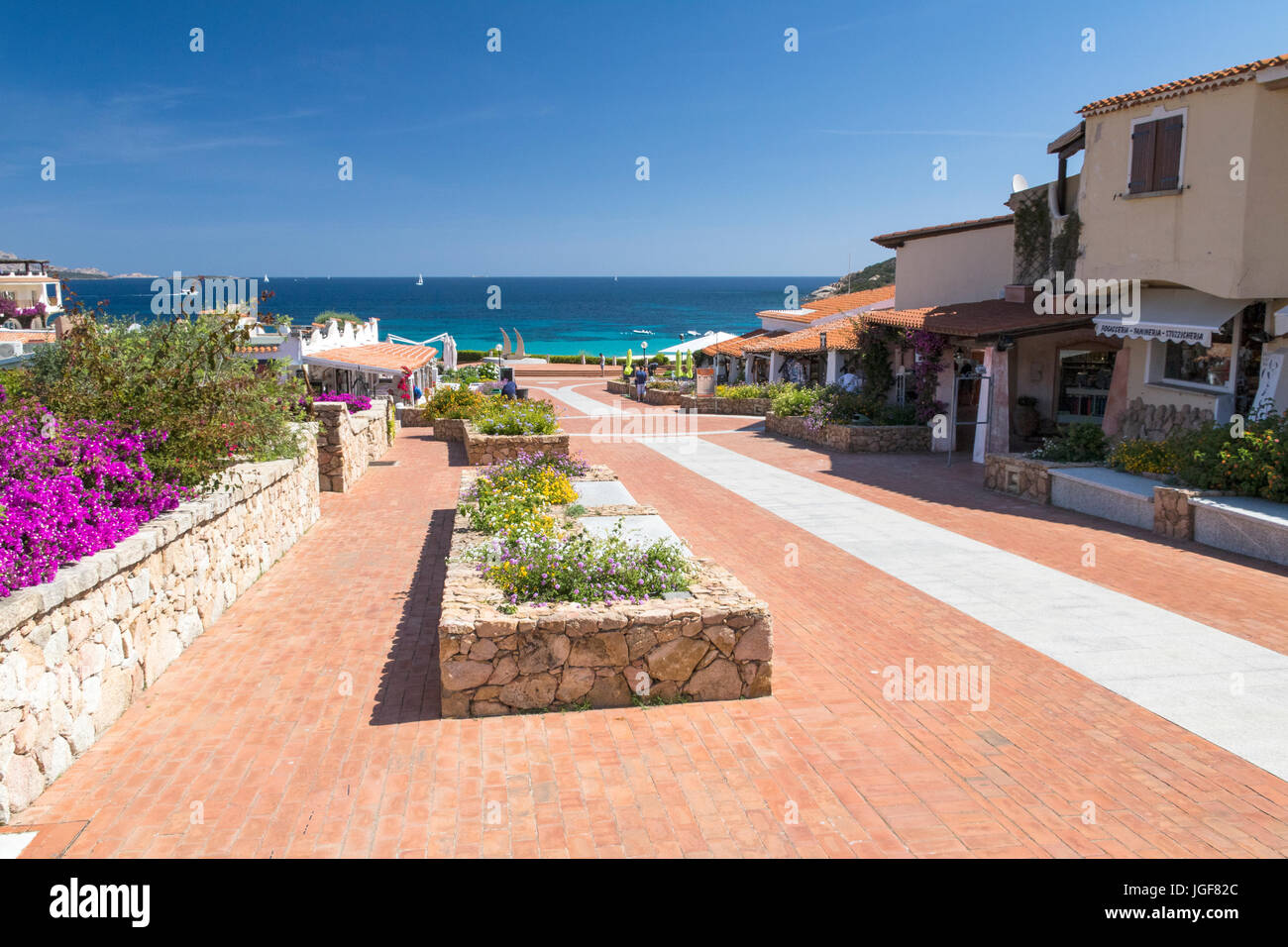 Tranquil Street View looking Towards Cala Batistoni Beach and Mediterannean Ocean with a Blue Sky: Baia Sardinia, Gallura, Sardinia, Italy. Stock Photo