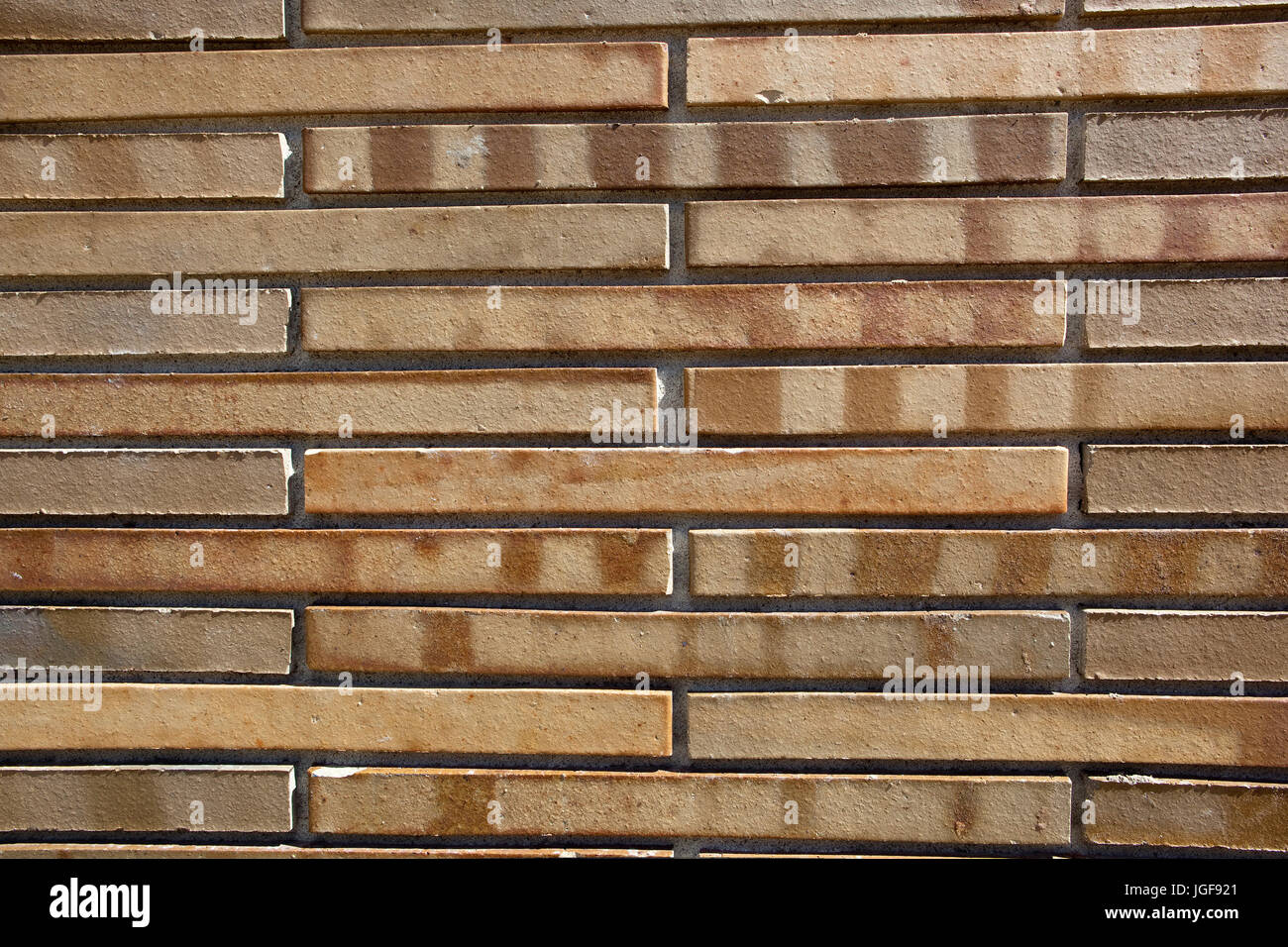 Patterns and texture of a new wall made of modern narrow bricks Stock Photo