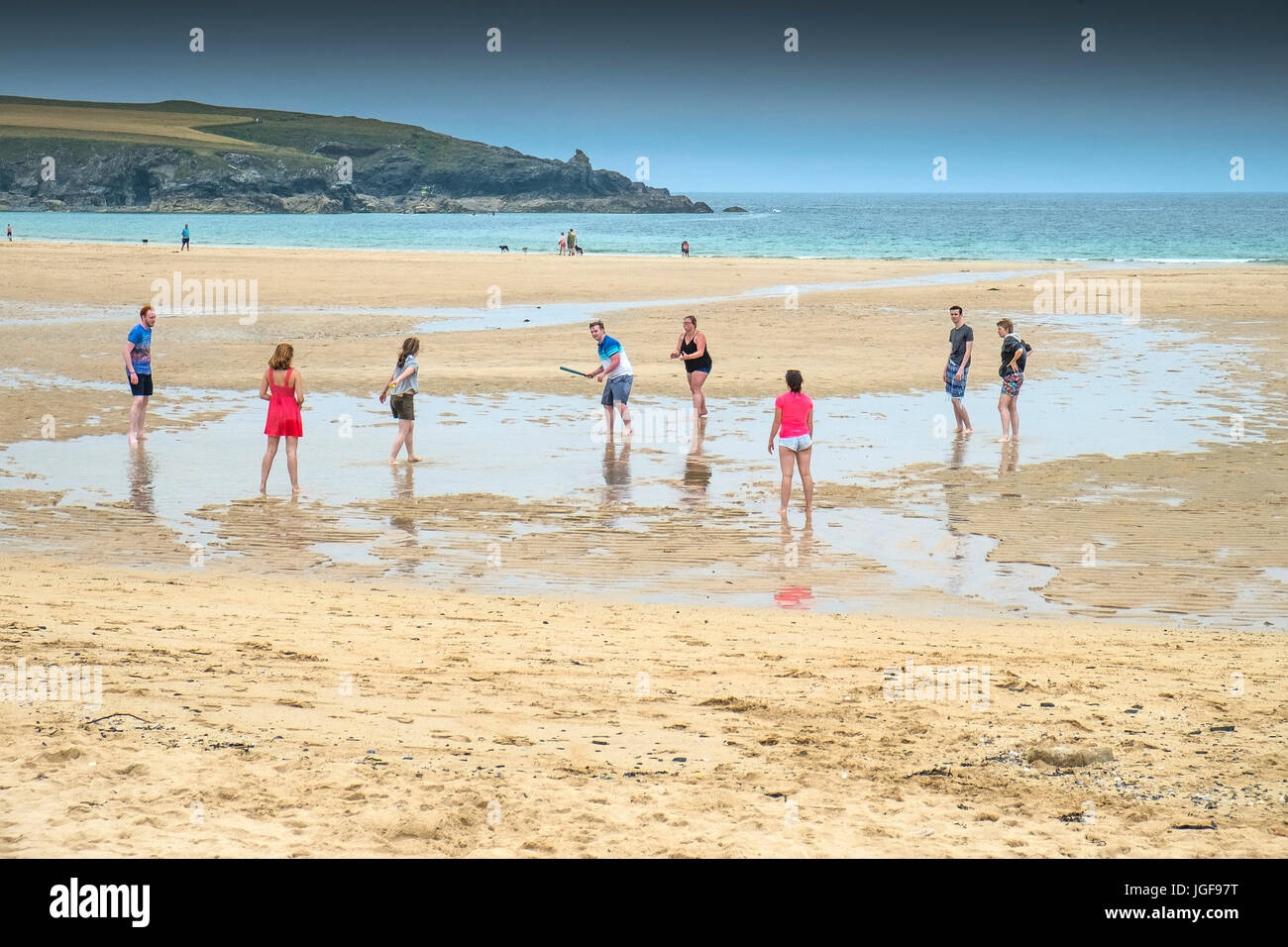 People on a beach.  Holidaymakers playing a game of rounders on the beach at Harlyn Bay on the North Cornwall coast. Stock Photo