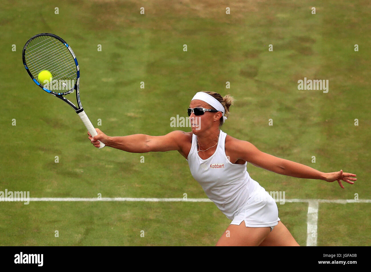 Kirsten Flipkens in action against Angelique Kerber on day four of the Wimbledon Championships at The All England Lawn Tennis and Croquet Club, Wimbledon. Stock Photo