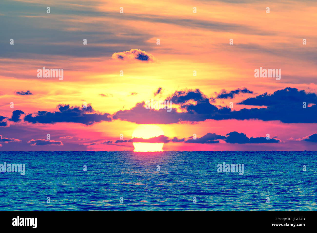Sunset sky over the surface of the sea Stock Photo - Alamy