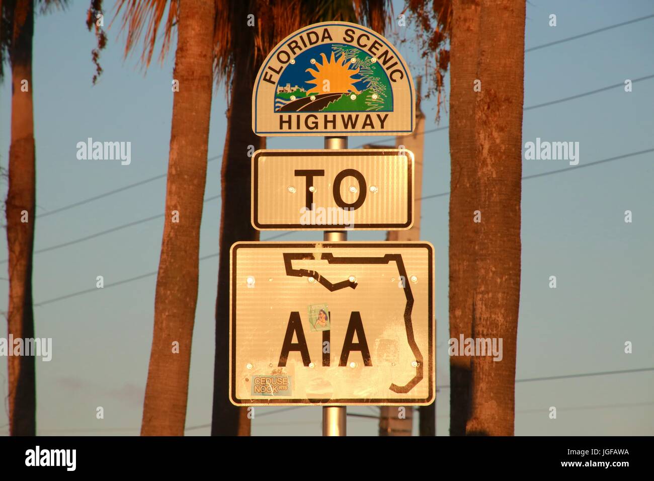 Florida Scenic Highway to A1A Sign at Sunset Framed by Two Palm Tree Trunks Stock Photo
