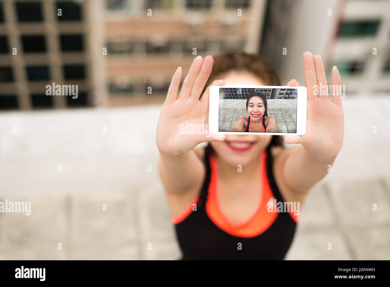 Woman taking a selfie photo after doing Yoga on a Rooftop in Hong Kong ...