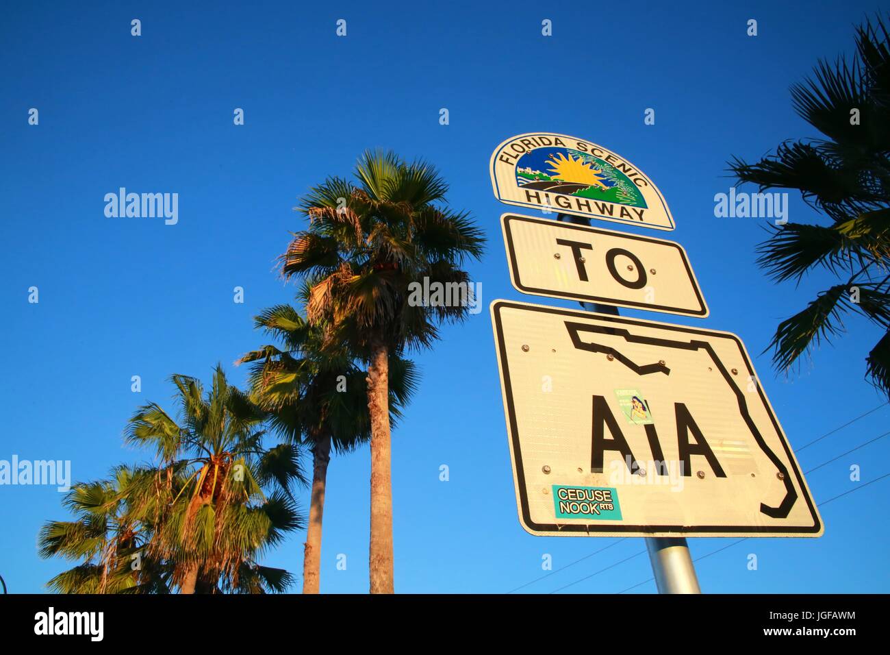 Florida Scenic Highway to A1A Sign at Sunset Beneath Palm Trees in Deerfield Beach on Hillsboro Boulevard West of Intracoastal Waterway Bridge Stock Photo