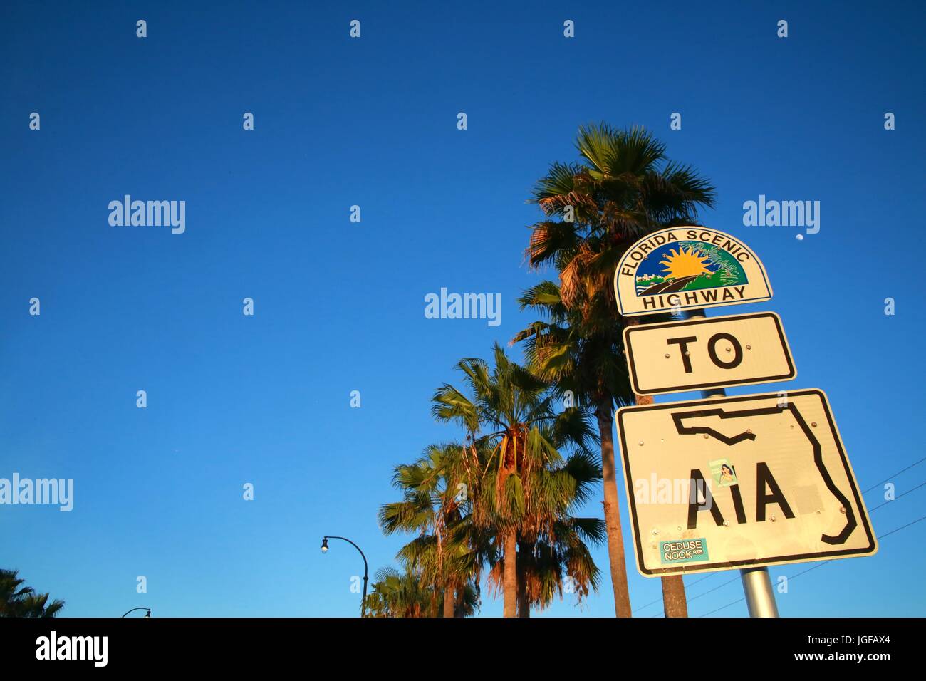 Florida Scenic Highway to A1A Sign at Sunset Beneath Palm Trees in Deerfield Beach on Hillsboro Boulevard West of Intracoastal Waterway Bridge Stock Photo
