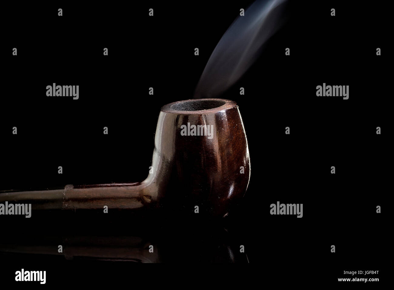 Lit Tobacco Smoking pipe reflective glass surface, with moving smoke