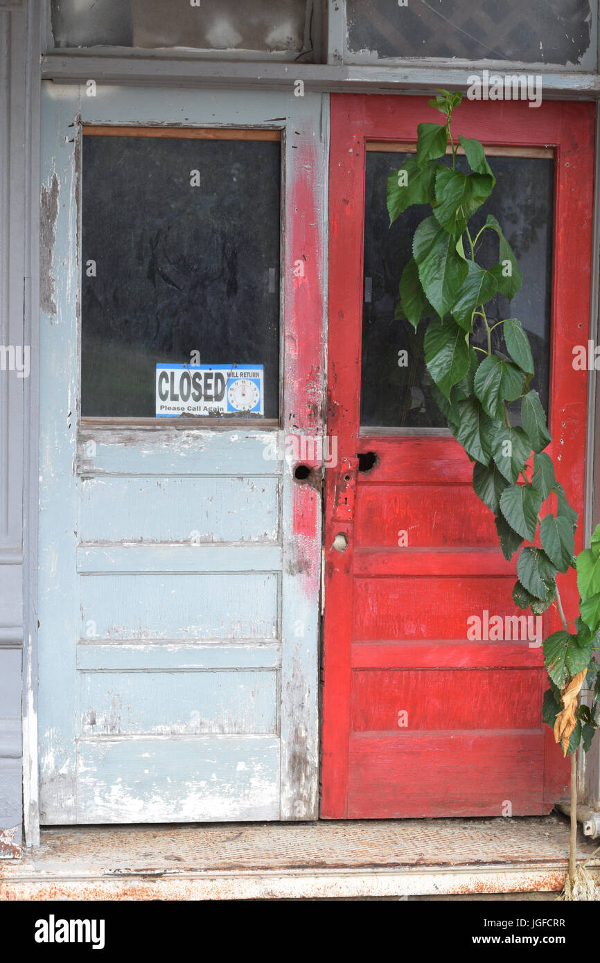 Close up of wooden doors of an abandoned business in an old building Stock Photo