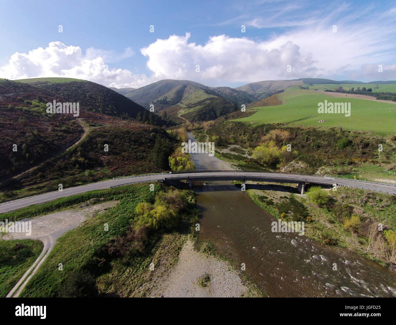 Curved bridge over Opuha River, between Geraldine and Fairlie, South Canterbury, South Island, New Zealand - drone aerial Stock Photo
