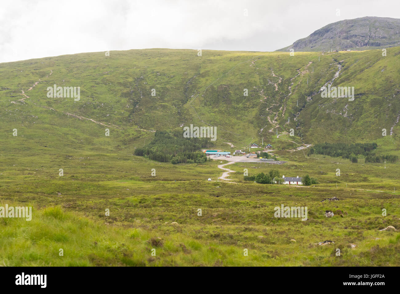 Glencoe Mountain Resort - with downhill mountain bike tracks  - and Black Rock Cottage in the foreground Stock Photo