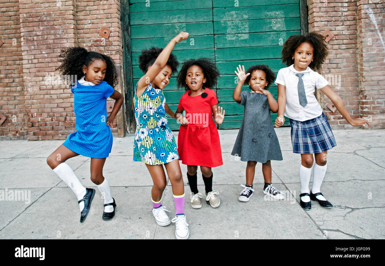 Girls dancing on city sidewalk Stock Photo Alamy