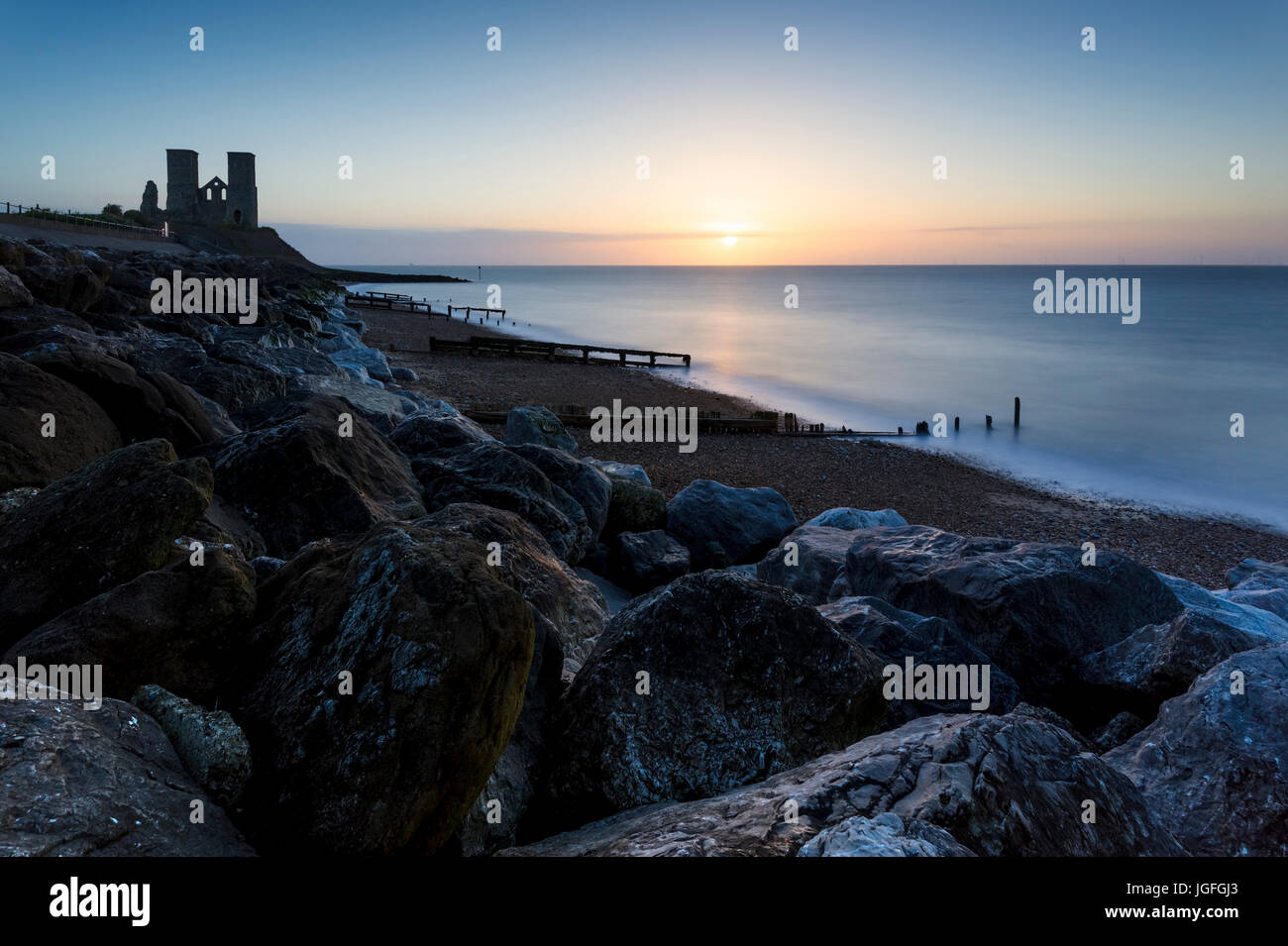 Sunset behind the Reculver Towers on the Kent coast near Herne Bay. Stock Photo