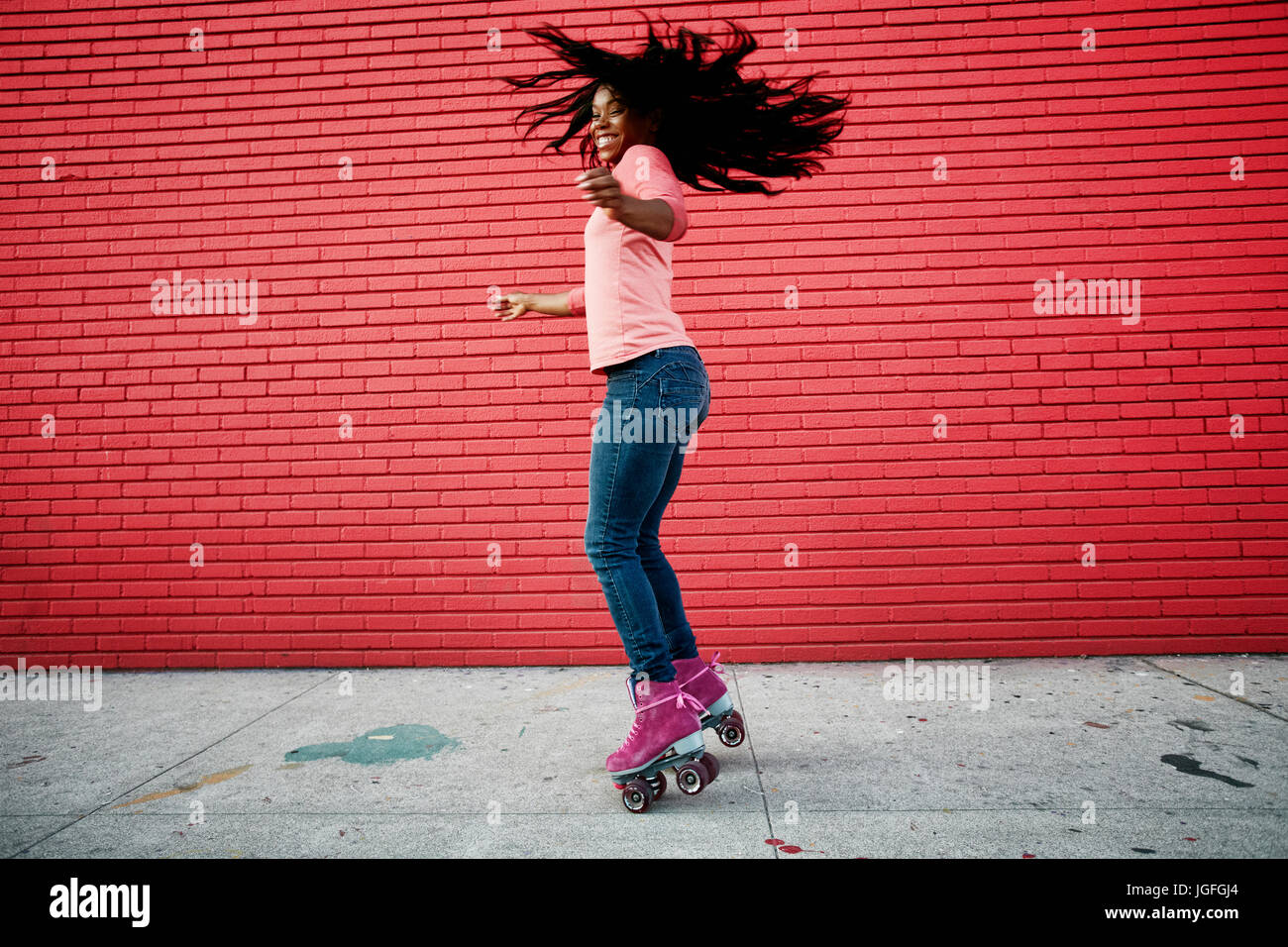Black woman dancing on roller skates on sidewalk Stock Photo Alamy
