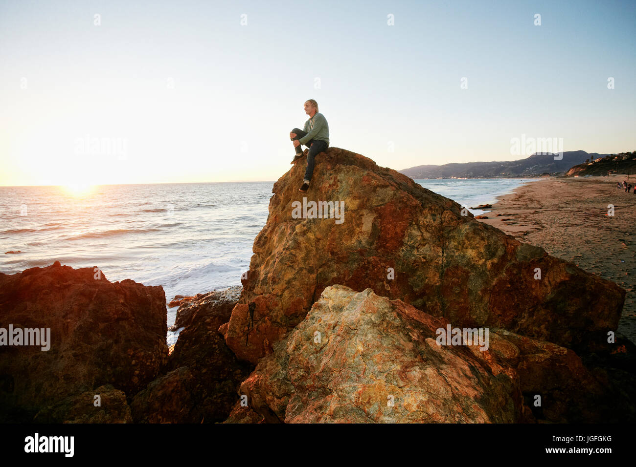 Man sitting rock hi-res stock photography and images - Alamy