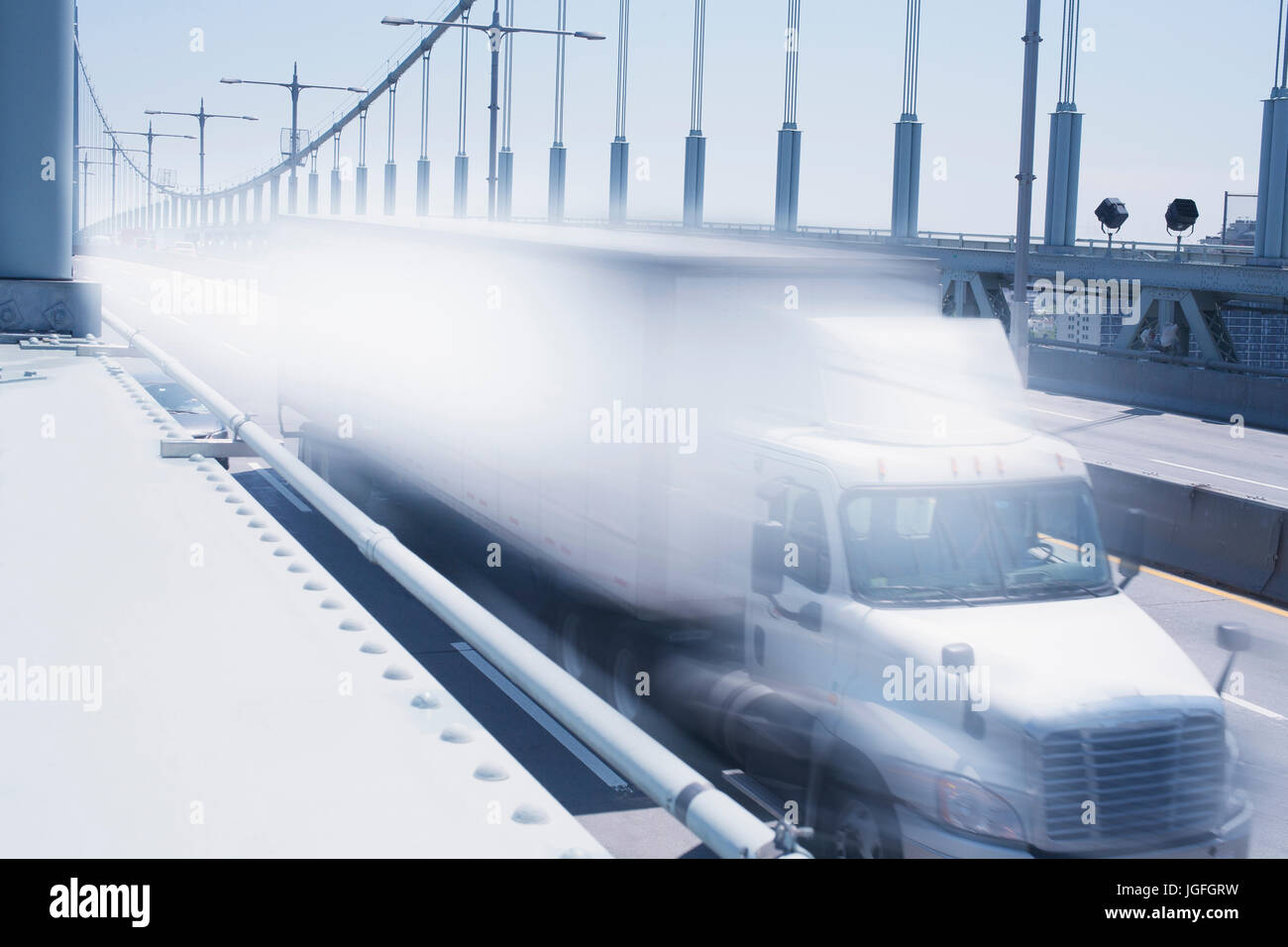 Semi-truck speeding on bridge Stock Photo