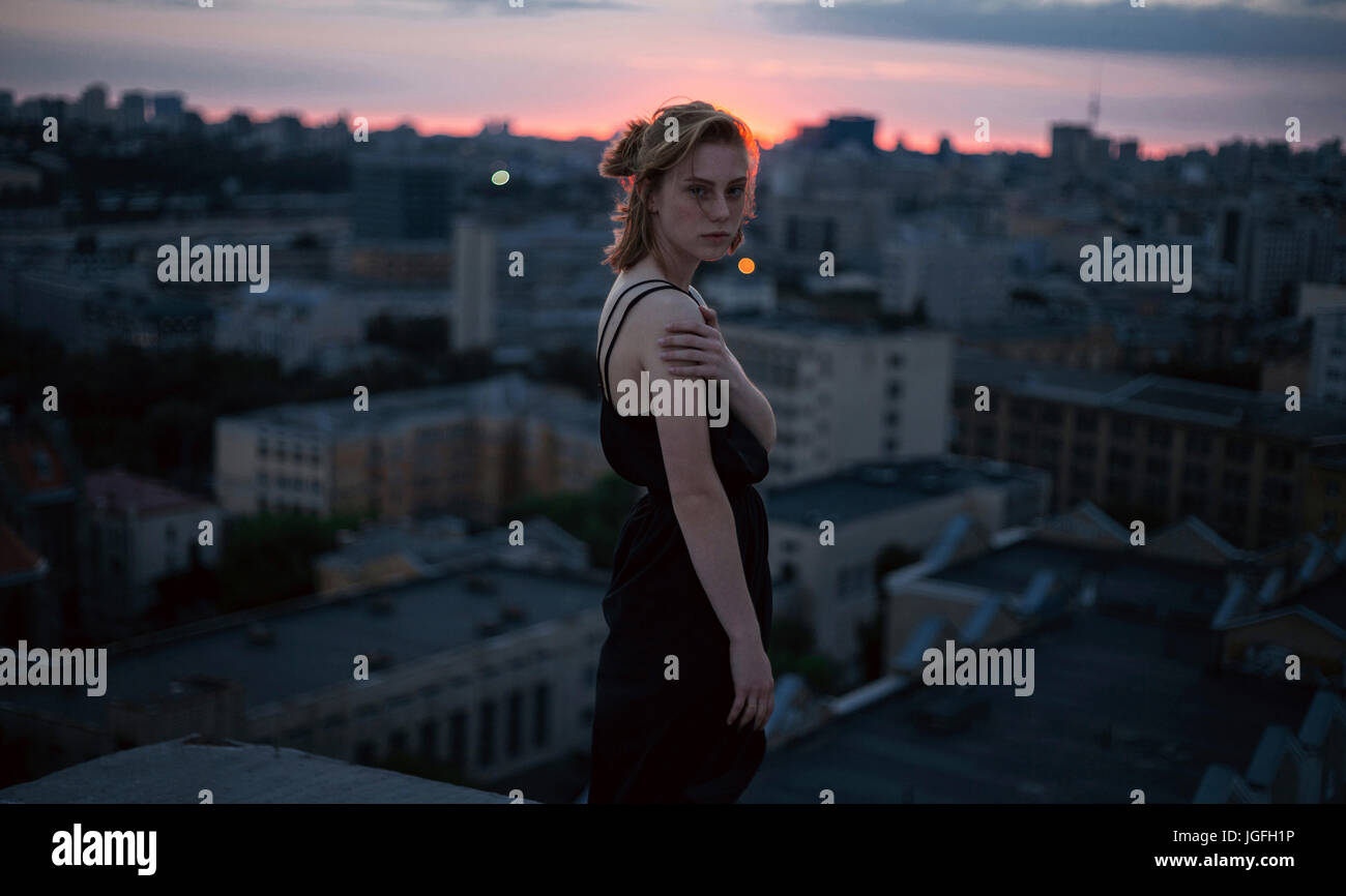 Portrait of serious Caucasian teenage girl overlooking cityscape Stock ...