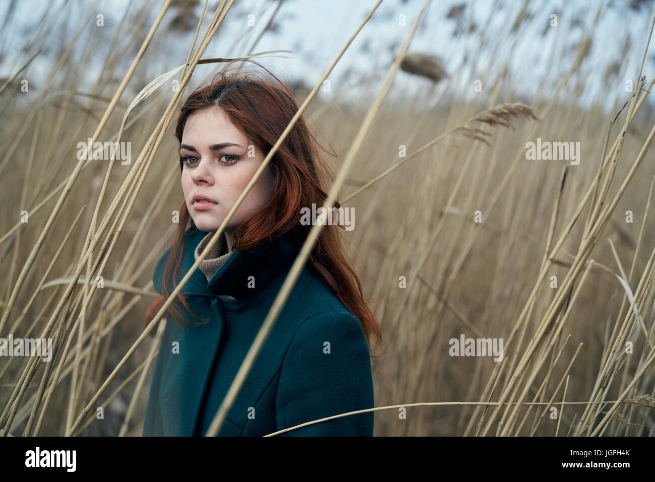 Portrait of serious Caucasian woman standing in field Stock Photo - Alamy
