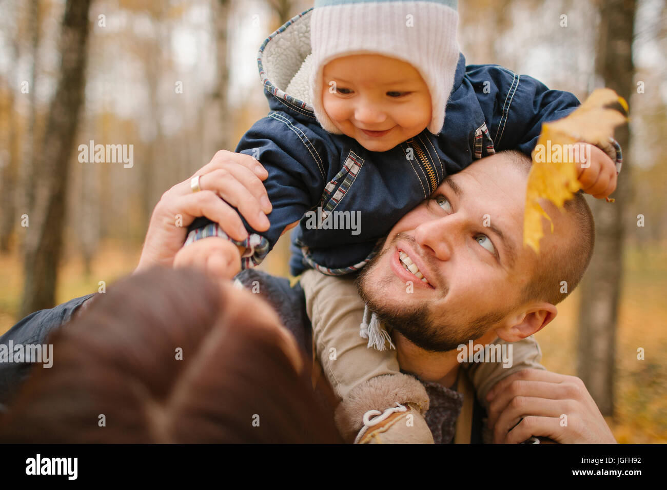 Middle Eastern father carrying baby son in autumn Stock Photo