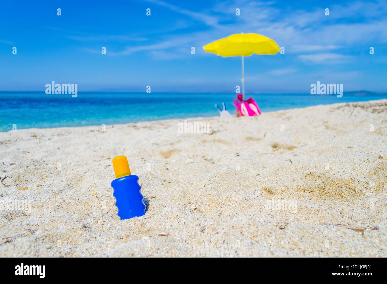 suntan lotion bottles on the sand Stock Photo