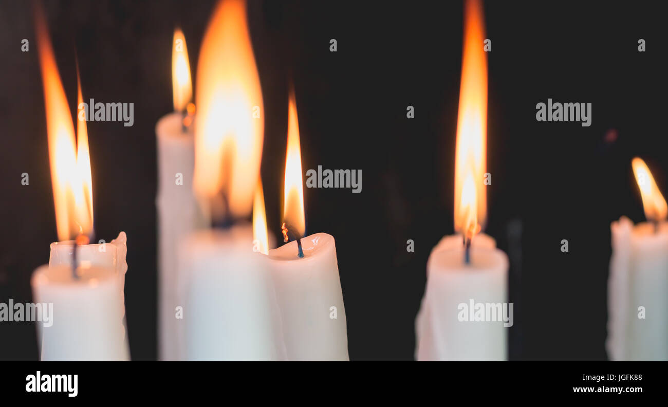 Lighted candles in the chapel of Lourdes, religious symbols Stock Photo