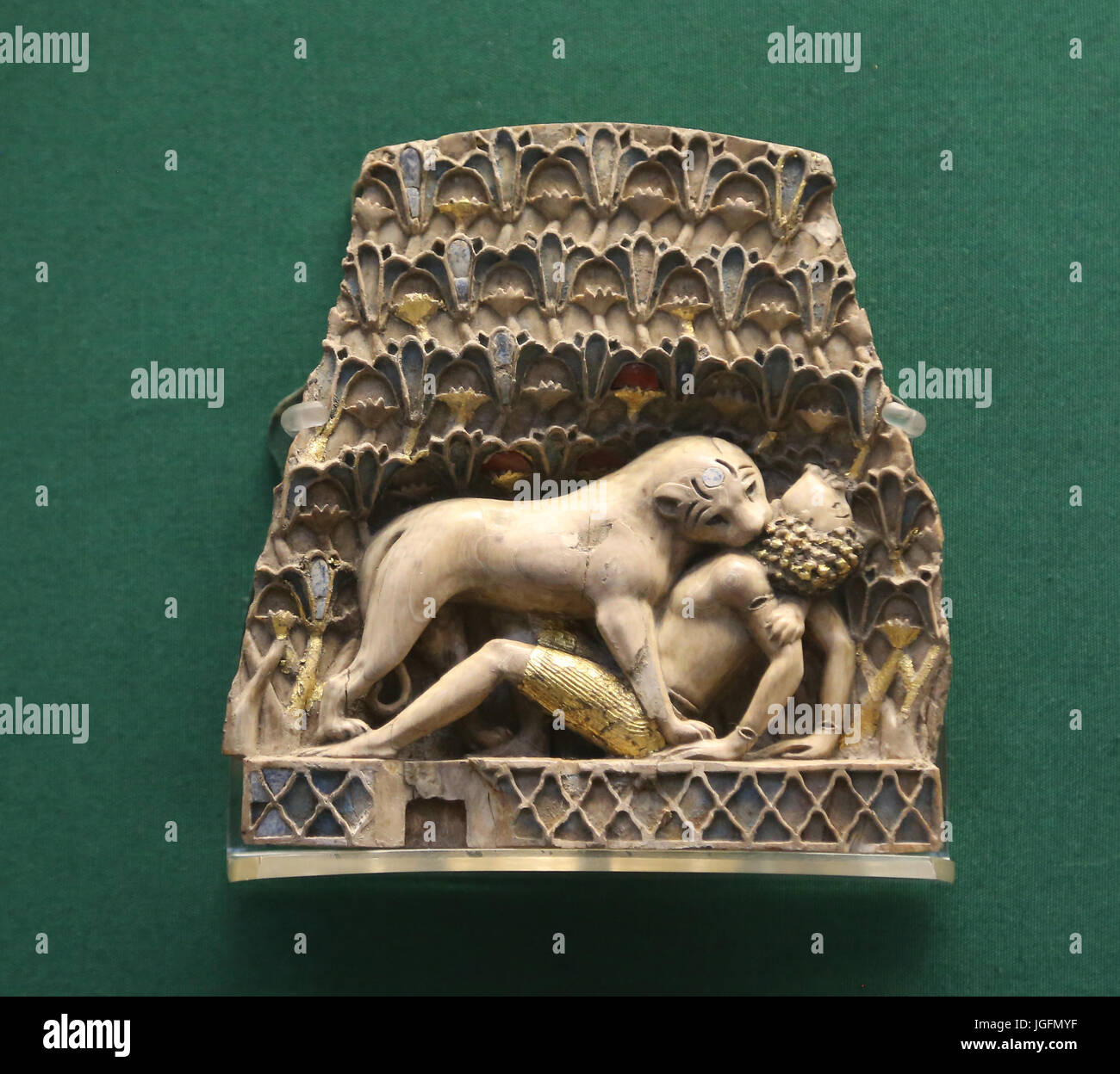 Ivory plaque which depicts a lion devouring a human. Nimrud. 9th  to 7th centuries BC. Nimrud, Iraq. Neo-Assyrians. British Museum. London. Stock Photo