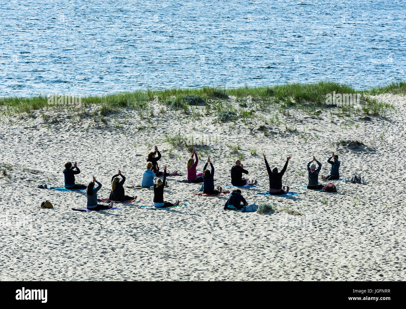 Morning beach yoga class, Chatham, Cape Cod, Massachusetts, USA. Stock Photo